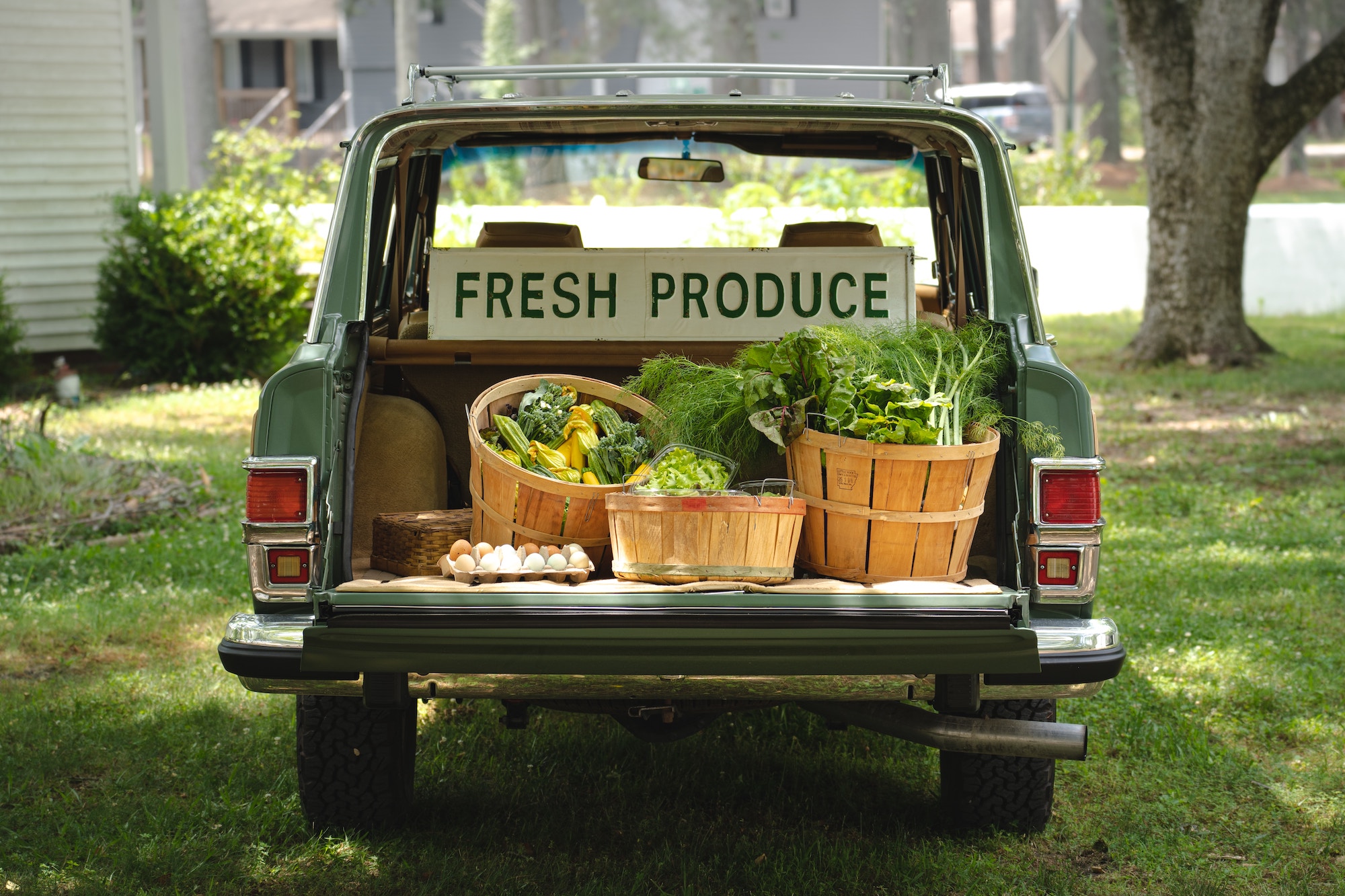 old truck with a fresh produce sign and fresh produce in the bed of the truck