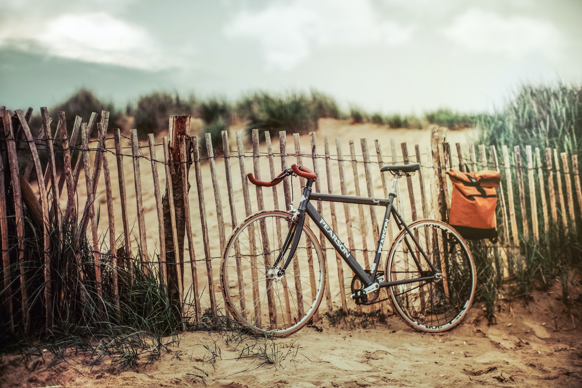 bike on fence on beach